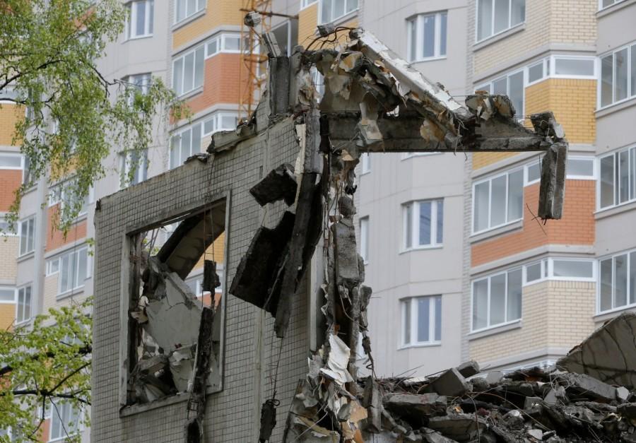 Debris of a building are seen in front of a newly built residential house in Moscow. Moscow government,Soviet-era apartments,Soviet-era apartment blocks,Soviet-era,Nikita Krushchev