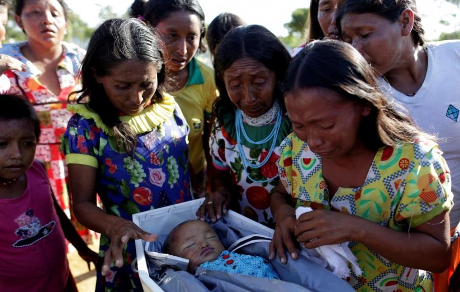 Relatives and friends attend the burial of 11-month-old Fernanda Rattia of the indigenous Warao people from the Orinoco Delta in eastern Venezuela, who died of pneumonia last Sunday, according to local media, in Manaus, Brazil. Venezuela,indigenous flee crisis,flee crisis,Caribbean coast,Manaus,Amazonian metropolis