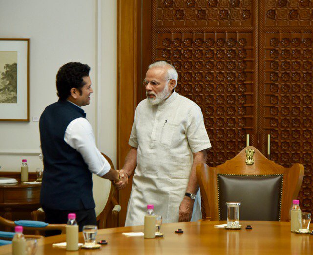 Legendary cricketer Sachin Tendulkar met Prime Minister Narendra Modi and received his blessings for his upcoming biographical film "Sachin: A Billion Dreams". Tendulkar shared a photograph on Twitter on Friday in which he is seen shaking hands with Modi. Sachin: A Billion Dreams,Sachin: A Billion Dreams Release,Sachin: A Billion Dreams movie Release,Sachin Tendulkar receives Narendra Modi blessings,Sachin Tendulkar meets Narendra Modi,Narendra Modi,PM Narendra Modi,Modi,Sachin Tendulkar