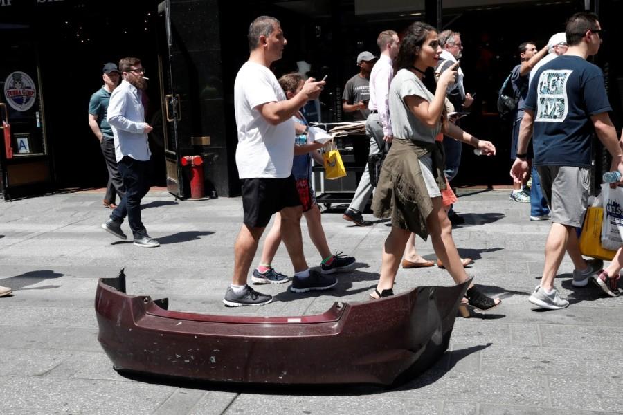A bumper from a vehicle that struck pedestrians and later crashed in Times Square is seen on the sidewalk in New York City, May 18, 2017. Car rams Times Square pedestrians,car crashed,New York City,Times Square