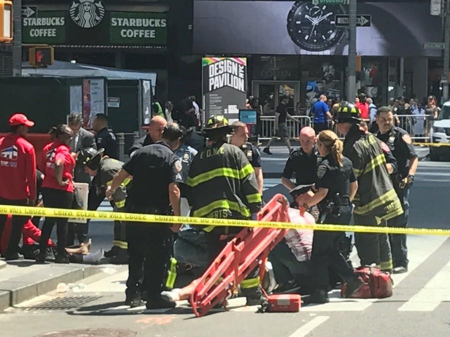First responders assist injured pedestrians after a vehicle struck pedestrians on a sidewalk in Times Square in New York, May 18, 2017. Car rams Times Square pedestrians,car crashed,New York City,Times Square