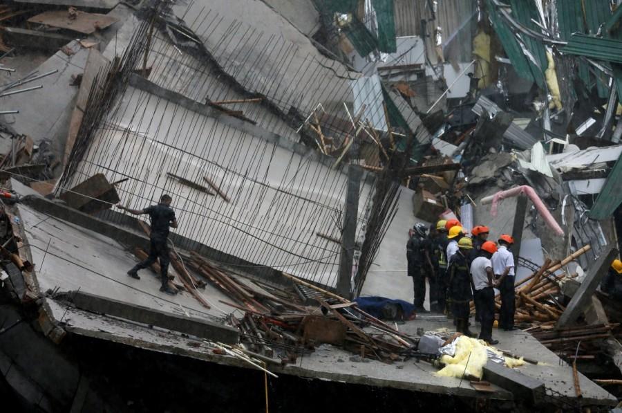 Military officials and fire brigade members work during a rescue mission in Colombo. Building collapse in Sri Lanka,Building collapse,building collapse in Colombo,Colombo