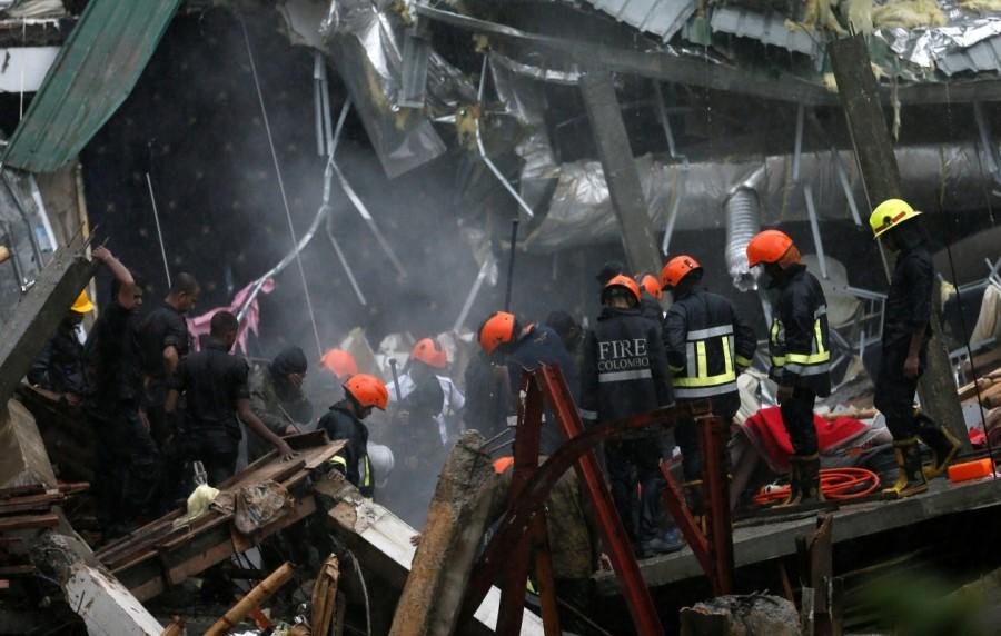 Military officials and fire brigade members work during a rescue mission in Colombo. Building collapse in Sri Lanka,Building collapse,building collapse in Colombo,Colombo