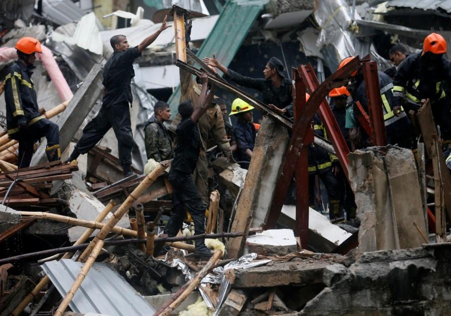 Military officials and fire brigade members work during a rescue mission in Colombo. Building collapse in Sri Lanka,Building collapse,building collapse in Colombo,Colombo