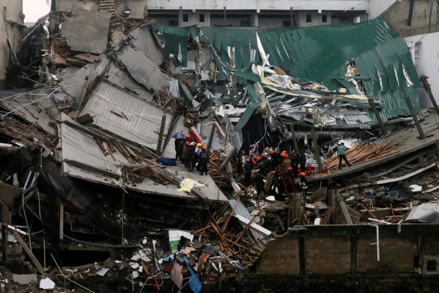 Military officials and fire brigade members work during a rescue mission in Colombo. Building collapse in Sri Lanka,Building collapse,building collapse in Colombo,Colombo