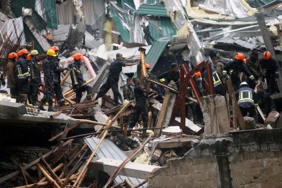 Military officials and fire brigade members work during a rescue mission in Colombo. Building collapse in Sri Lanka,Building collapse,building collapse in Colombo,Colombo