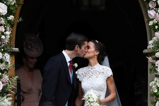 Pippa Middleton kisses her new husband James Matthews, following their wedding ceremony at St Mark's Church in Englefield, west of London.