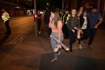 Concert goers react after fleeing the Manchester Arena in northern England where U.S. singer Ariana Grande had been performing in Manchester.
