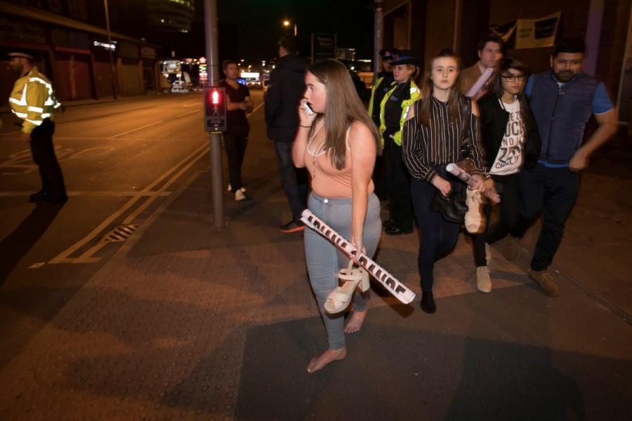 Concert goers react after fleeing the Manchester Arena in northern England where U.S. singer Ariana Grande had been performing in Manchester. Deadly blast at Manchester Ariana Grande concert,blast at Manchester Ariana Grande concert,blast at Manchester Ariana,singer Ariana Grande,Ariana Grande,Manchester,blast ay Manchester,Manchester blast