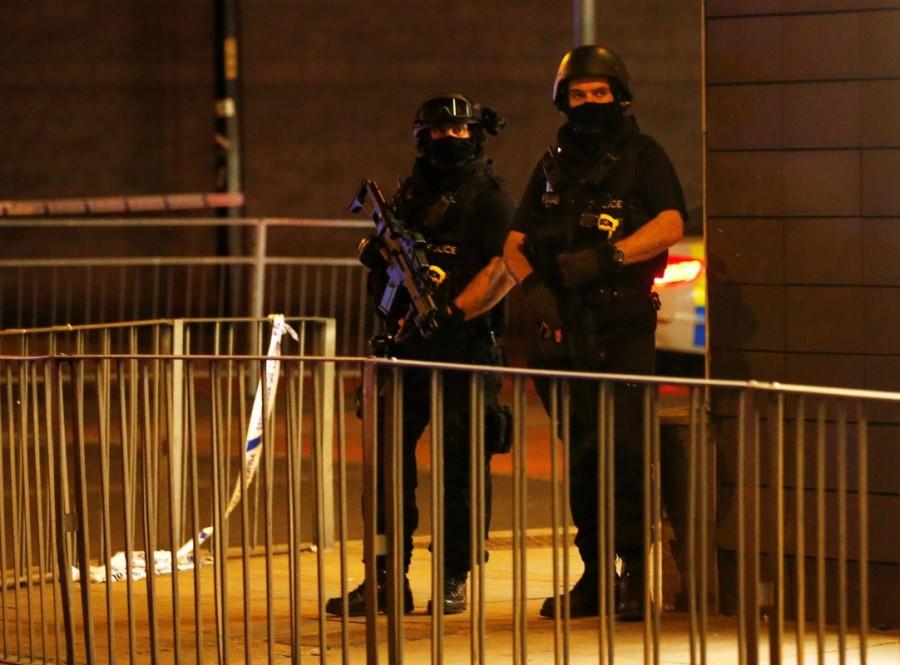 Armed police officers stand next to a police cordon outside the Manchester Arena, where U.S. singer Ariana Grande had been performing. Deadly blast at Manchester Ariana Grande concert,blast at Manchester Ariana Grande concert,blast at Manchester Ariana,singer Ariana Grande,Ariana Grande,Manchester,blast ay Manchester,Manchester blast