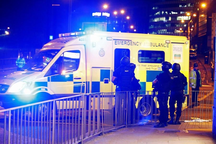 Armed police officers stand near the Manchester Arena. Deadly blast at Manchester Ariana Grande concert,blast at Manchester Ariana Grande concert,blast at Manchester Ariana,singer Ariana Grande,Ariana Grande,Manchester,blast ay Manchester,Manchester blast