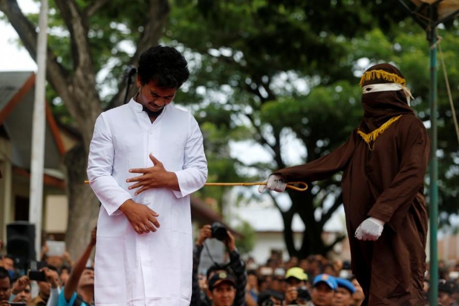 An Indonesian man is publicly caned for having gay sex in Banda Aceh, Aceh province, Indonesia. Gay sex,gay sex in Indonesia,Two men publicly caned,Indonesia for having gay sex,Two men caned 83 times for gay sex,Two men caned 83 times
