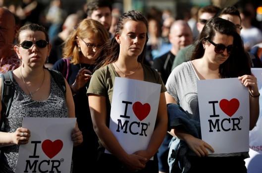Women wait to take part in a vigil for the victims of an attack on concert goers at Manchester Arena, in central Manchester, Britain May 23, 2017.