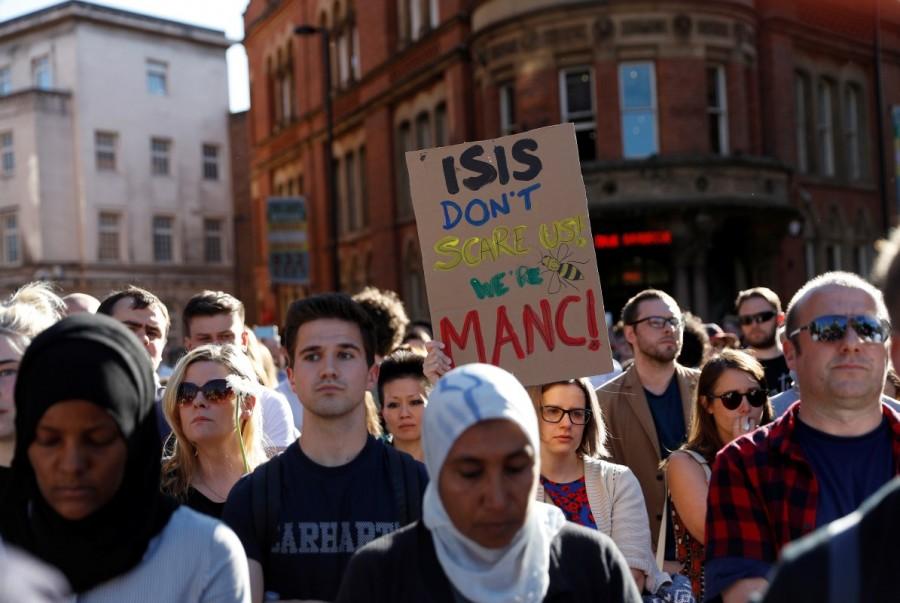 A woman holds a placard as people take part in a vigil for the victims of an attack on concert goers at Manchester Arena, in central Manchester, Britain May 23, 2017. Manchester,Mourning for Manchester,Manchester blast,Ariana Grande concert,Manchester Ariana Grande concert explosion,Manchester mourns