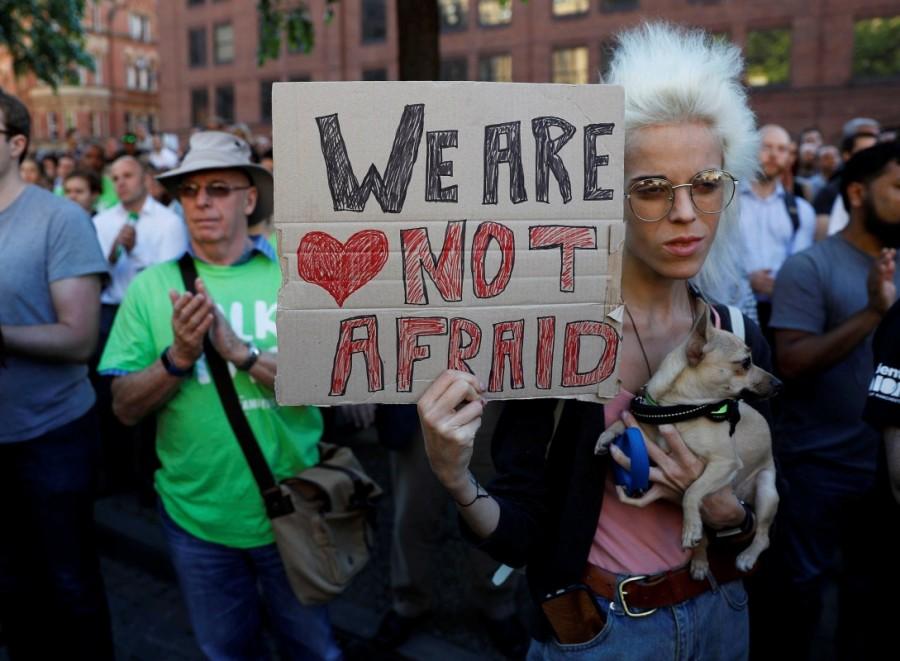 A woman holds a placard as they take part in a vigil for the victims of an attack on concert goers at Manchester Arena, in central Manchester, Britain May 23, 2017. Manchester,Mourning for Manchester,Manchester blast,Ariana Grande concert,Manchester Ariana Grande concert explosion,Manchester mourns