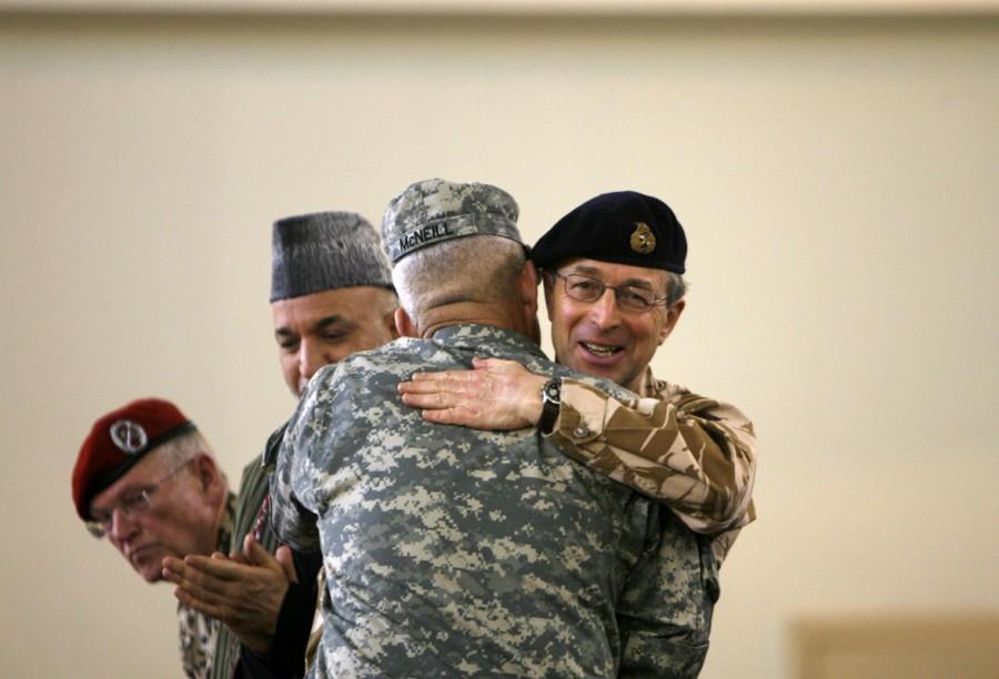 Outgoing NATO commander in Afghanistan British General David Richards (R) hugs NATO's new commander in Afghanistan U.S. General Dan McNeill during NATO's change of command ceremony in Kabul February 4, 2007. The United States, which has just doubled its combat troops in Afghanistan, takes over command of the 33,000-strong NATO force in the country on Sunday amid warnings of a bloody spring offensive by the Taliban. Second from left is Afghan President Hamid Karzai and left is Commander Allied Joint Force Command Brunssum German General Egon Ramms. Treaty Organization,North American Treaty Organization,NATO in the modern world,NATO