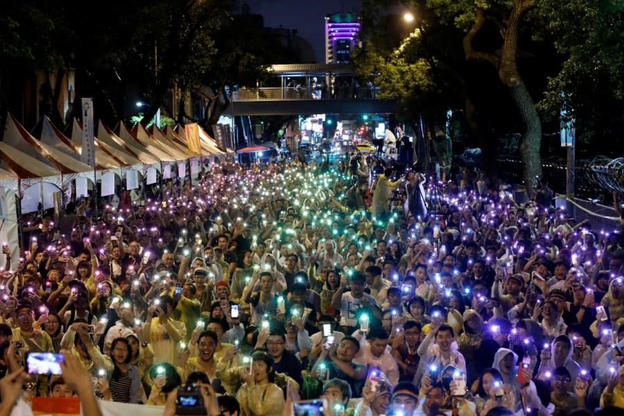Supporters wave their mobile phone torches in the colors of the rainbow during a rally after Taiwan's constitutional court ruled that same-sex couples have the right to legally marry, the first such ruling in Asia, in Taipei, Taiwan. Same-sex marriage,same-sex,Taiwan same-sex marriage,Taiwan legalizes same-sex marriage,legally marry,same-sex couples