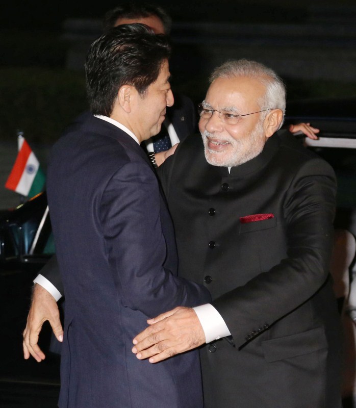 India's Prime Minister Narendra Modi (R) is welcomed by Japan's Prime Minister Shinzo Abe upon his arrival at the State Guest House in Kyoto, western Japan, in this photo released by Kyodo August 30, 2014. Prime Minister Narendra Modi,Narendra Modi,Narendra Modi hugs,Modi special,3 years of Modi,3 years of Narendra Modi