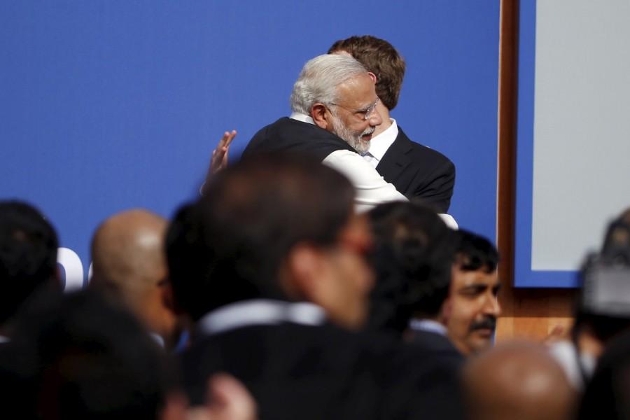 Indian Prime Minister Narendra Modi (L) embraces Facebook CEO Mark Zuckerberg after a town hall at Facebook's headquarters in Menlo Park, California September 27, 2015. Prime Minister Narendra Modi,Narendra Modi,Narendra Modi hugs,Modi special,3 years of Modi,3 years of Narendra Modi