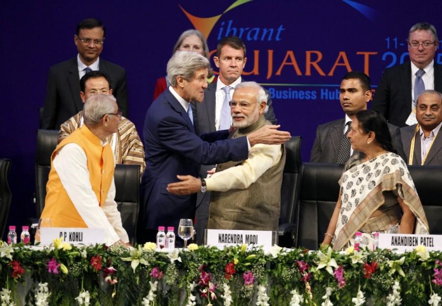 U.S. Secretary of State John Kerry (front, 2nd L) and India's Prime Minister Narendra Modi (front, 2nd R) gesture after shaking hands at the Vibrant Gujarat Summit in Gandhinagar in the western Indian state of Gujarat January 11, 2015. Prime Minister Narendra Modi,Narendra Modi,Narendra Modi hugs,Modi special,3 years of Modi,3 years of Narendra Modi