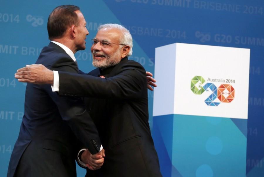 Australian Prime Minister Tony Abbott (L) embraces India?s Prime Minister Narendra Modi as he officially welcomes leaders to the G20 summit in Brisbane November 15, 2014. Prime Minister Narendra Modi,Narendra Modi,Narendra Modi hugs,Modi special,3 years of Modi,3 years of Narendra Modi