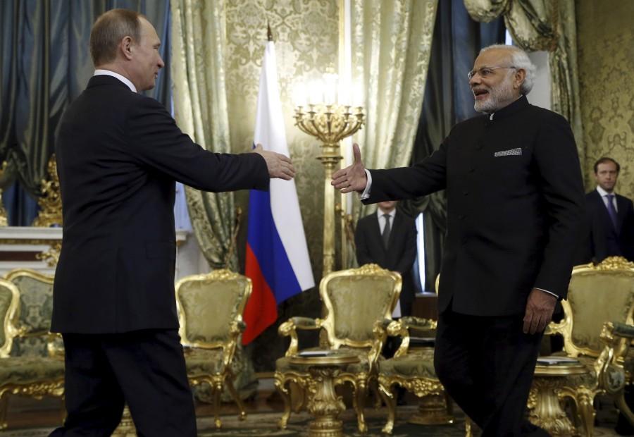 Russia's President Vladimir Putin (L) shakes hands with India's Prime Minister Narendra Modi during a meeting at the Kremlin in Moscow, Russia, December 24, 2015. Narendra Modi,PM Narendra Modi,Modi,PM Modi,3 yrs of Narendra Modi govt,Narendra Modi government turns 3,NaMo,NaMo 3 years