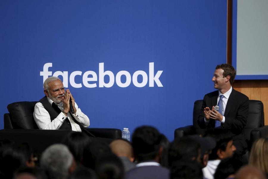 Indian Prime Minister Narendra Modi (L) gives a "namaste", a gesture of greeting, as Facebook CEO Mark Zuckerberg applauds on stage after a town hall at Facebook's headquarters in Menlo Park, California September 27, 2015. Narendra Modi,PM Narendra Modi,Modi,PM Modi,3 yrs of Narendra Modi govt,Narendra Modi government turns 3,NaMo,NaMo 3 years