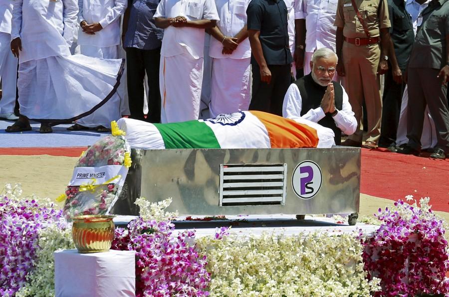 Indian Prime Minister Narendra Modi gestures after placing a wreath on the body of former President A.P.J. Abdul Kalam, wrapped with the national flag, during the funeral ceremony in Rameswaram, India, July 30, 2015. Kalam, considered the father of the country's missile programme, died on Monday in hospital at the age of 83, a doctor said. Popularly known as "Missile Man," Kalam led the scientific team that developed missiles able to carry India's nuclear warheads. He became a national folk hero after helping oversee nuclear tests in 1998 that solidified India's status as a nuclear weapons state. Narendra Modi,PM Narendra Modi,Modi,PM Modi,3 yrs of Narendra Modi govt,Narendra Modi government turns 3,NaMo,NaMo 3 years