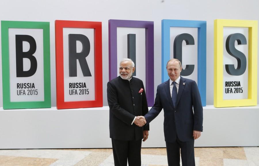Russian President Vladimir Putin (R) greets Indian Prime Minister Narendra Modi during the welcoming ceremony at the BRICS Summit in Ufa, Russia, July 9, 2015. Ufa is hosting the BRICS and the Shanghai Cooperation Organization (SCO) summits from July 9-10. Narendra Modi,PM Narendra Modi,Modi,PM Modi,3 yrs of Narendra Modi govt,Narendra Modi government turns 3,NaMo,NaMo 3 years