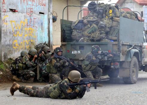 Government troops are seen during an assault on insurgents from the so-called Maute group, who have taken over large parts of Marawi City in southern Philippines.