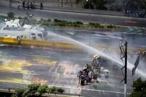 Opposition supporters clash with riot security forces in Caracas.