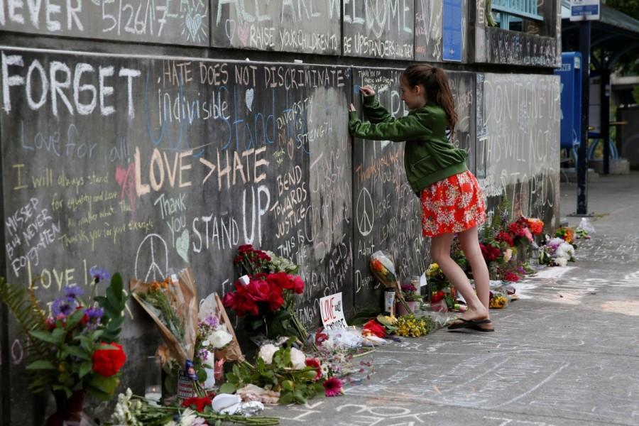 A girl leaves a message at a makeshift memorial for two men who were killed on a commuter train while trying to stop another man from harassing two young women who appeared to be Muslim, in Portland, Oregon, May 29, 2017. Oregon,Portland train stabbing victims,Portland train stabbing,Memorial for Portland train stabbing victims,Portland
