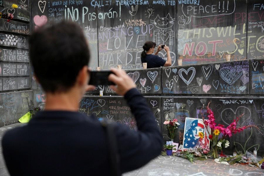 People take photos at a makeshift memorial. Oregon,Portland train stabbing victims,Portland train stabbing,Memorial for Portland train stabbing victims,Portland