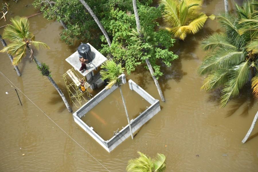 People wait for rescue teams on top of a building in a village in Matara. Massive flooding in Sri Lanka,flooding in Sri Lanka,Historic floods,Flood in Sri Lanka,Sri Lanka flood