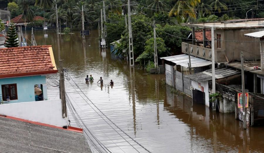 A group of men walk through a flooded road during a rescue mission in Nagoda village in Kalutara. Massive flooding in Sri Lanka,flooding in Sri Lanka,Historic floods,Flood in Sri Lanka,Sri Lanka flood