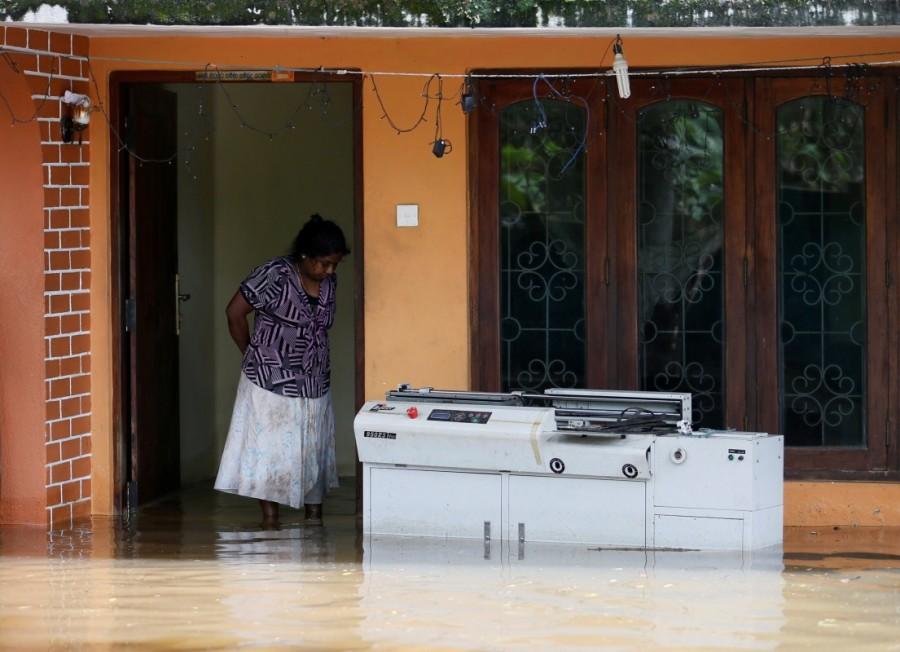 A woman looks on inside her flooded house in Dodangoda village in Kalutara. Massive flooding in Sri Lanka,flooding in Sri Lanka,Historic floods,Flood in Sri Lanka,Sri Lanka flood