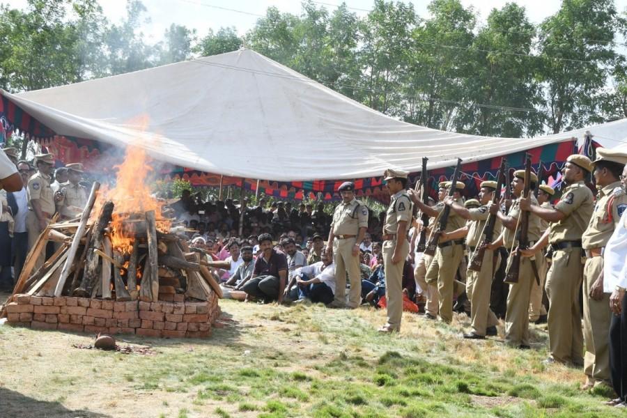 Leading film personalities, politicians and fans besides family members, relatives and friends bid a tearful adieu to Rao, who breathed his last on Tuesday in a private hospital after prolonged illness. He was 75. The last rites were performed at Rao's farm house at Moinabad, about 60 km from Hyderabad. Rao's eldest son Harihara Prabhu lit the funeral pyre as a police contingent presented gun salute. The funeral was performed adjacent to the 'samadhi' of Rao's wife. Dasari Narayana Rao,Dasari Narayana Rao cremated with state honours,Dasari Narayana Rao cremated,Dasari Narayana Rao cremated pics,Dasari Narayana Rao cremated images,Dasari Narayana Rao cremated stills,Dasari Narayana Rao cremated pictures,Dasari Narayan