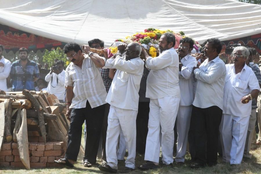 "Telugu film industry has lost a pillar. He was institution in himself," said Naidu. He recalled that from a modest background, Rao become director, writer, actor and later politician and worked hard for the welfare of weaker sections. Celebrities like Pawan Kalyan, Junior NTR, Daggubati Venkatesh, Allu Arjun, Narayana Murthy, Naga Babu, Vijayachander, Raghvendra Rao, Dil Raju, Mohan Babu, Krishna, Nassar and filmmaker Trivikram paid their last respects. Dasari Narayana Rao,Dasari Narayana Rao cremated with state honours,Dasari Narayana Rao cremated,Dasari Narayana Rao cremated pics,Dasari Narayana Rao cremated images,Dasari Narayana Rao cremated stills,Dasari Narayana Rao cremated pictures,Dasari Narayan