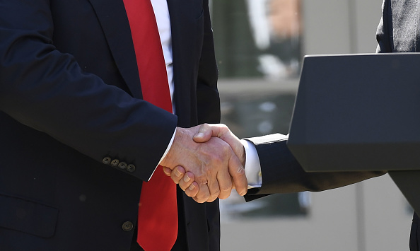 The head of the Environmental Protection Agency Scott Pruitt (R), shakes hands with US President Donald Trump after he announced his decision to withdraw the US from the Paris Climate Accords in the Rose Garden of the White House in Washington, DC, on June 1, 2017. 'As of today, the United States will cease all implementation of the non-binding Paris accord and the draconian financial and economic burdens the agreement imposes on our country,' Trump said. President Donald Trump,Donald Trump,Paris Climate Accord,Barack Obama,Donald Trump withdraws from Paris Climate Accord