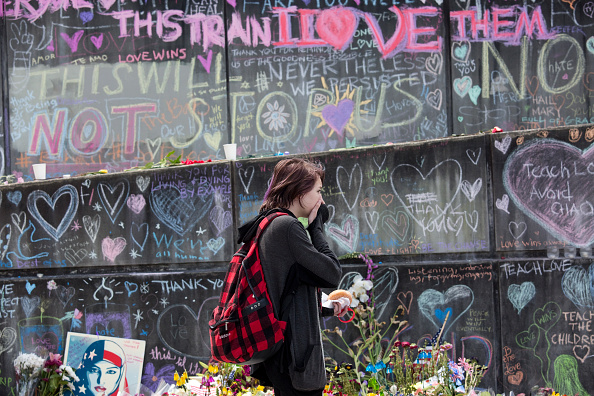 A woman looks at a memorial at the Hollywood Transit Center on June 2, 2017 in Portland, Oregon. The center was the site where last week three men were stabbed, two fatally, after they stood up for two women who were being harassed on a MAX train. Ricky Best and Taliesin Myrddin Namkai Meche,Ricky Best,Taliesin Myrddin Namkai Meche,MAX train,Train Victims,Portland Honors MAX Train Victims