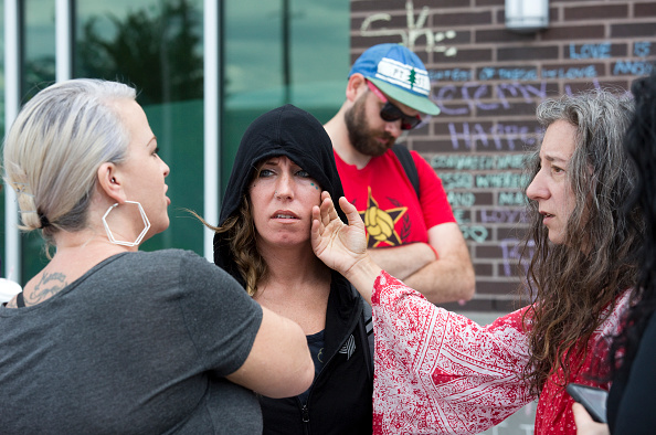 Friends comfort one another as they meet to pay their respects at an impromptu memorial at the Hollywood Transit Center on June 2, 2017 in Portland, Oregon. The center was the site where last week three men were stabbed, two fatally, after they stood up for two women who were being harassed on a MAX train. Ricky Best and Taliesin Myrddin Namkai Meche,Ricky Best,Taliesin Myrddin Namkai Meche,MAX train,Train Victims,Portland Honors MAX Train Victims