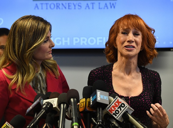 Comedian Kathy Griffin (R) reacts during a news conference to discuss the comedian's 'motivation' behind a photo of her holding what appeared to be a prop depicting US President Donald Trump's bloodied, severed head, with her attorney, Lisa Bloom in Woodland Hills, California on June 2, 2017. Kathy Griffin and her Attorney Lisa Bloom,Kathy Griffin,Attorney Lisa Bloom,Lisa Bloom,Kathy Griffin holds press conference,Attorney Lisa Bloom holds press conference,Griffin's controversial photo shoot