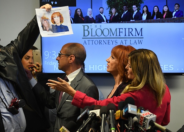 Comedian Kathy Griffin (2ndR) speaks at a news conference to discuss the comedian's 'motivation' behind a photo of her holding what appeared to be a prop depicting US President Donald Trump's bloodied, severed head, as a man holds up the image of Griffin holding the head, with her attorney, Lisa Bloom (R) in Woodland Hills, California on June 02, 2017. Kathy Griffin and her Attorney Lisa Bloom,Kathy Griffin,Attorney Lisa Bloom,Lisa Bloom,Kathy Griffin holds press conference,Attorney Lisa Bloom holds press conference,Griffin's controversial photo shoot