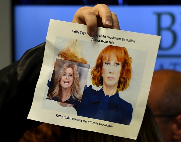 A man interrupts the end of a press conference by comedian Kathy Griffin as he holds up an image of Griffin holding the 'severed head' of her attorney, Lisa Bloom in Woodland Hills, California on June 02, 2017. Kathy Griffin and her Attorney Lisa Bloom,Kathy Griffin,Attorney Lisa Bloom,Lisa Bloom,Kathy Griffin holds press conference,Attorney Lisa Bloom holds press conference,Griffin's controversial photo shoot