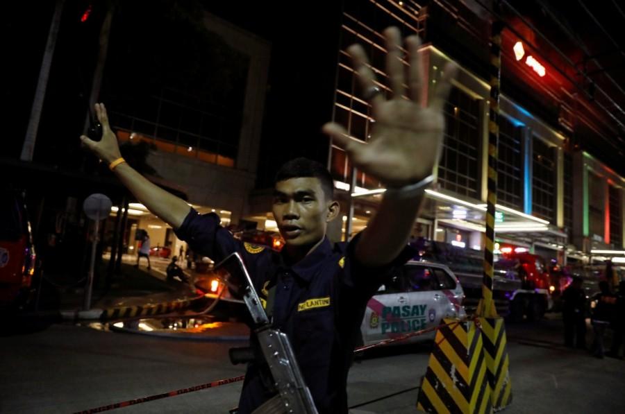 A security guard stops photographers from entering the vicinity of Resorts World Manila after gunshots and explosions were heard in Pasay City, Metro Manila, Philippines. Gun shots,explosions in Manila,Manila,Explosions in Manila,gunshots in Manila,gunshots at resort,gunshots at resort in Manila