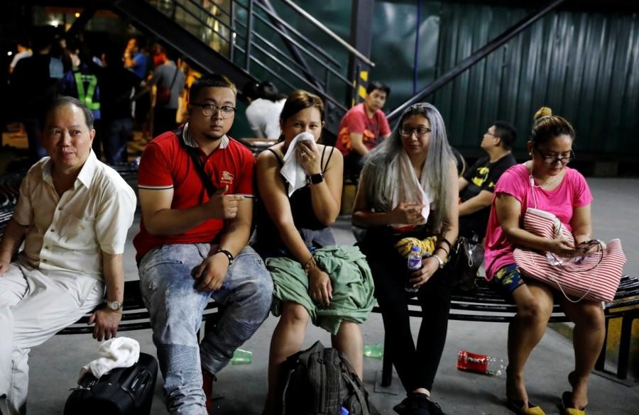 Tourists are pictured after being evacuated from a Resorts World building in Pasay City, Metro Manila, Philippines. Gun shots,explosions in Manila,Manila,Explosions in Manila,gunshots in Manila,gunshots at resort,gunshots at resort in Manila