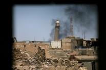 Al-Hadba minaret at the Grand Mosque is seen through a building window in the old city of Mosul, Iraq.