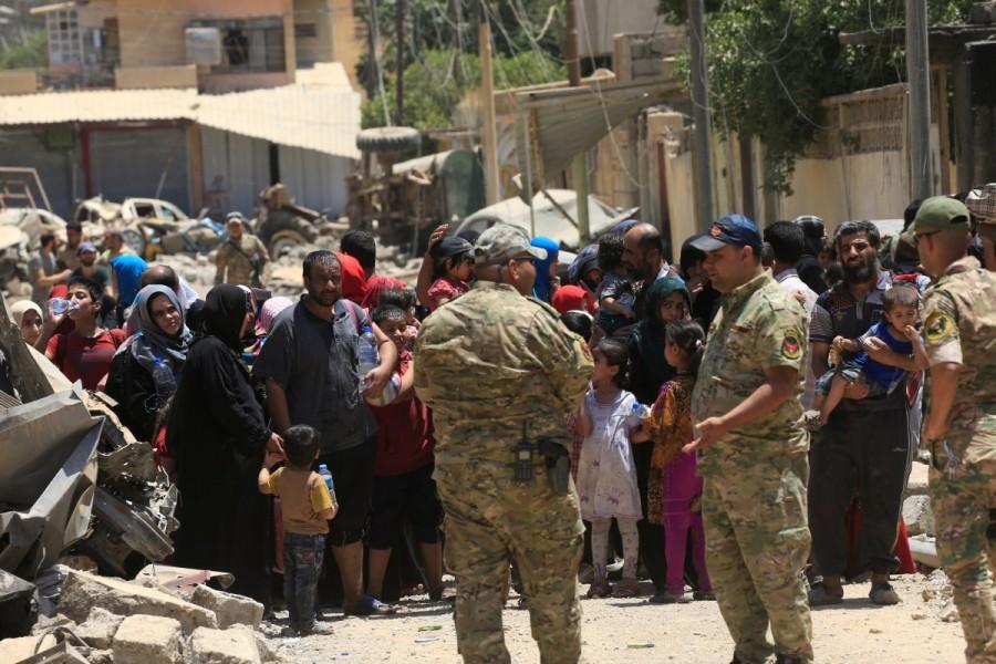 Displaced Iraqi people who fled homes during a fight between Iraqi forces and Islamic State militants in al-Zanjili neighbourhood, north of Old City district of Mosul. Islamic State,Islamic State militants,Mosul,Grand al-Nuri Mosque,Mosul mosque