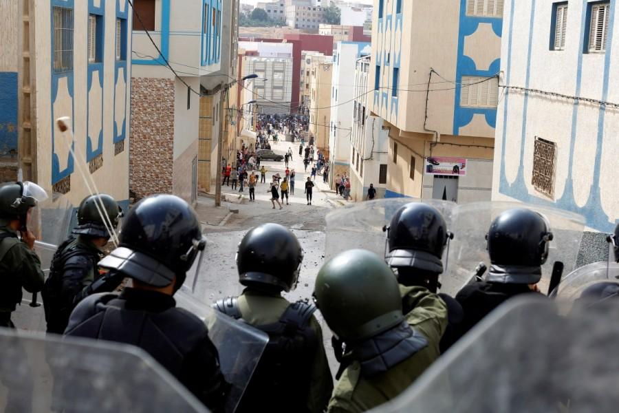 Protesters throw stones towards riot police during a demonstration against alleged corruption in the provincial town of Imzouren, Morocco, June 2, 2017. Rare protests rock Morocco,Morocco,protests rock Morocco,protests at Morocco,northern Moroccan