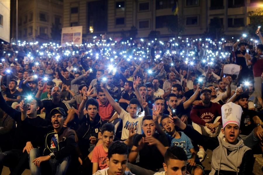 Protesters hold their phones as they shout slogans during a demonstration in the northern town of Al-Hoceima against official abuses and corruption, Morocco June 1, 2017 Rare protests rock Morocco,Morocco,protests rock Morocco,protests at Morocco,northern Moroccan